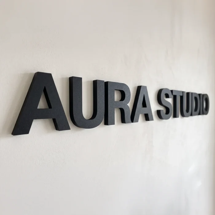 black dimensional lettering sign on the white wall