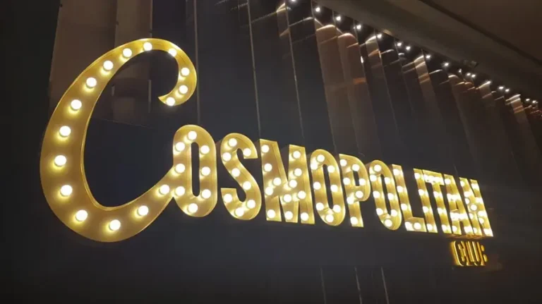 Photo of the light bulb channel letters sign used by the Cosmopolitan brand in the storefront.